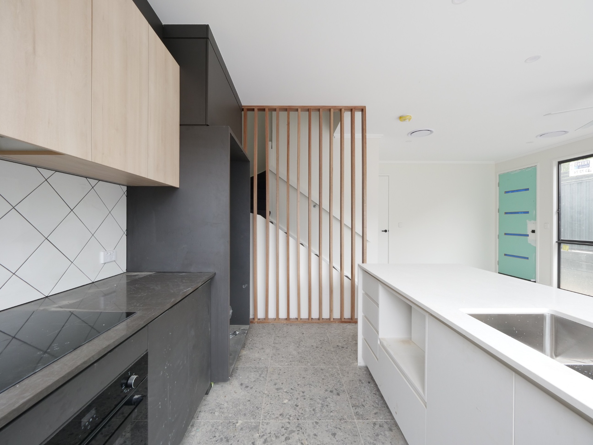 Before photo of unfurnished kitchen and stair void